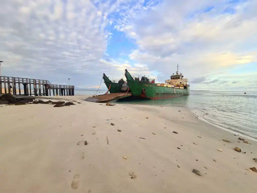 The Malu Titan Landing Craft with its ramp lowered onto the beach.