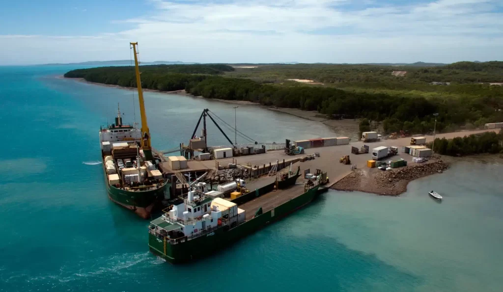 Two Sea Swift Vessels alongside a wharf on a remote island.